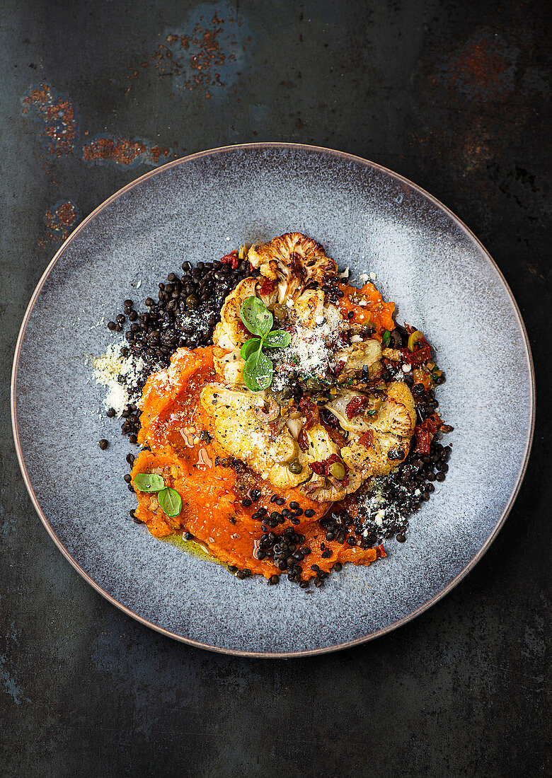 Cauliflower steak with sweet potato puree and beluga lentils