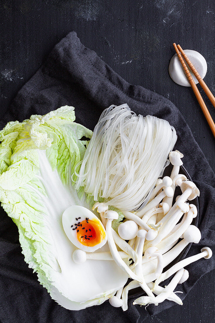 Glass noodles, chinese cabbage, enoki mushrooms and boiled egg for cooking Ramen