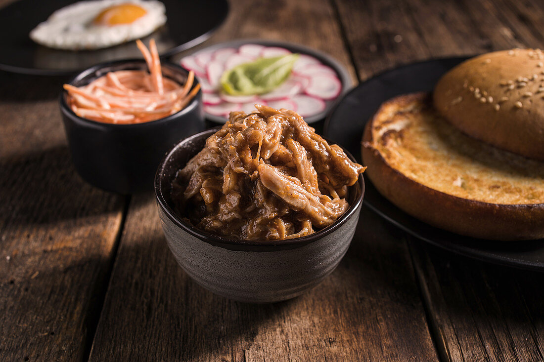 Ingredients for pulled pork hamburger with vegetables and fried egg