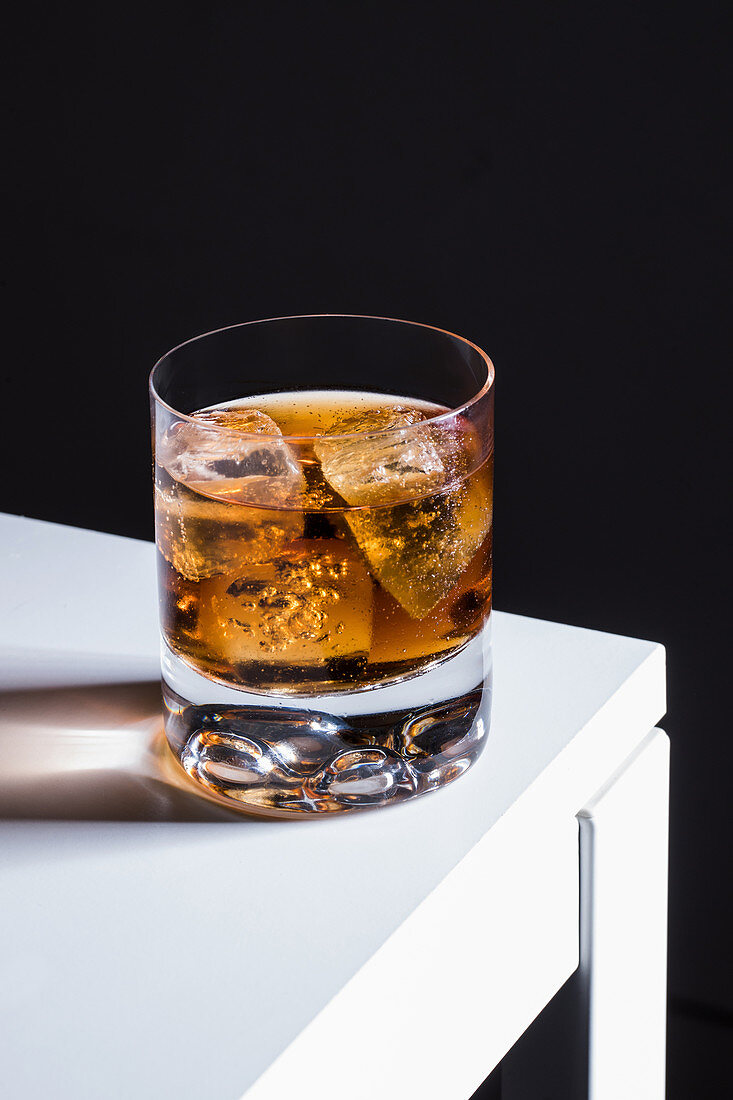 Old fashioned cocktail with ice cubes