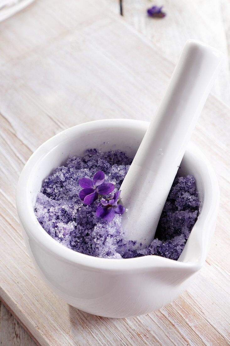 Sugar made from violet petals in a mortar