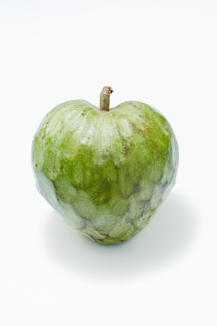 A cherimoya against a white background