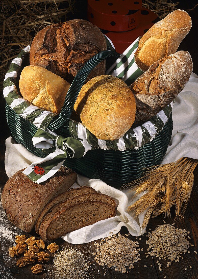 Basket of fresh bread & baguettes, décor: grain, nuts