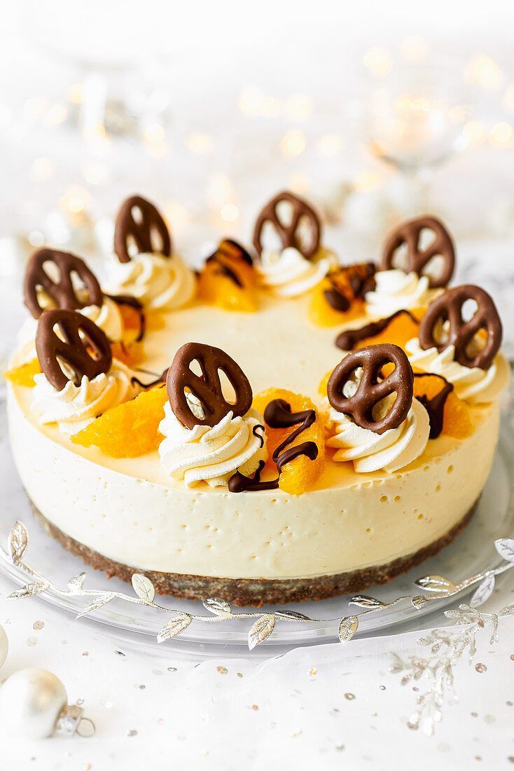 Orange cream cheese cake decorated with chocolate pretzels (for Christmas)