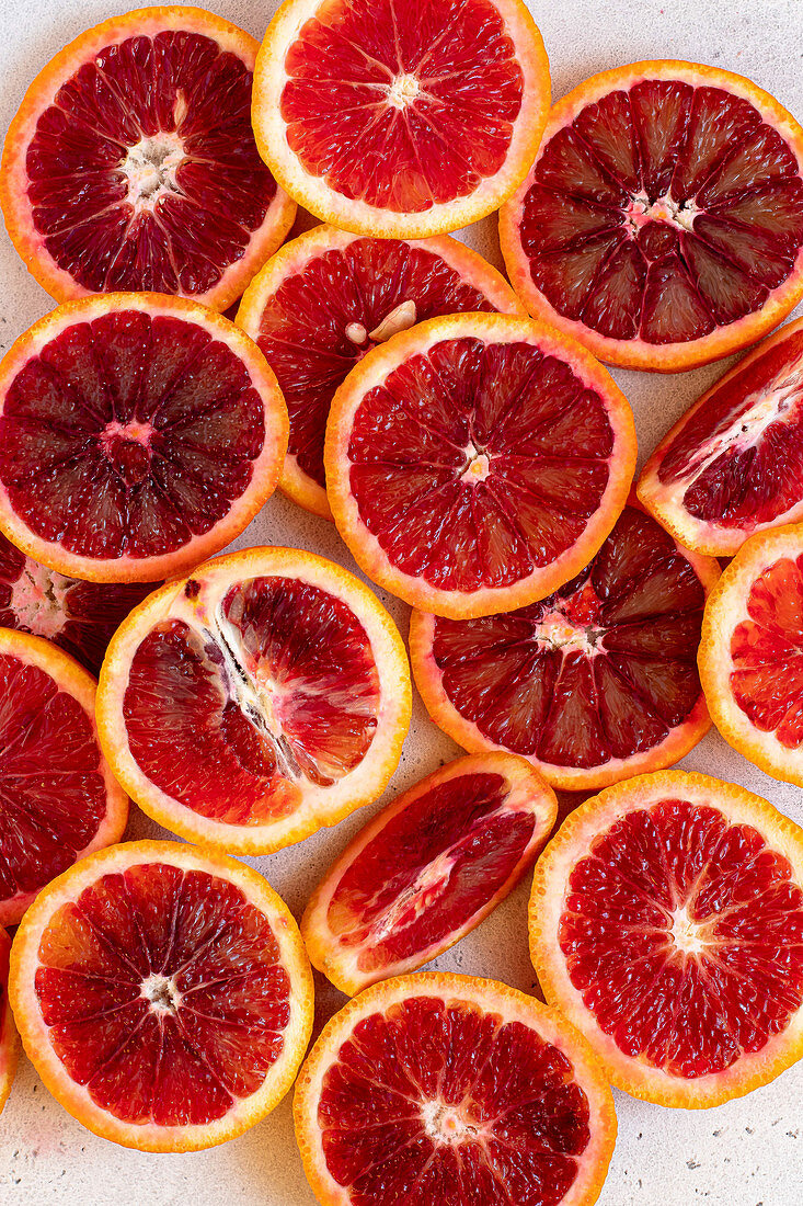 Slices of blood oranges on a white background