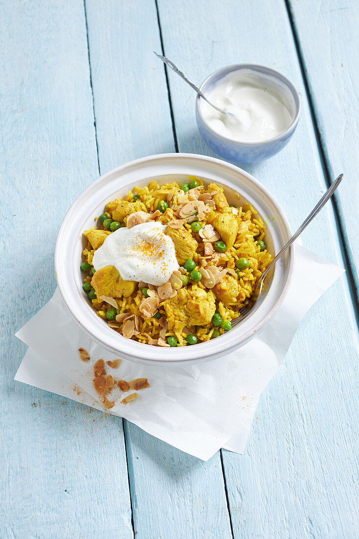 Spicy pilaf with chicken, peas, and almonds
