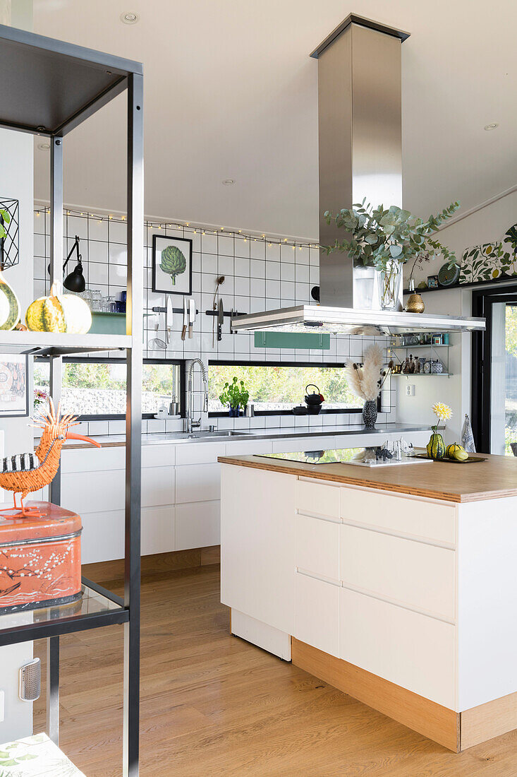 Kitchen island with extractor hood in white, modern kitchen