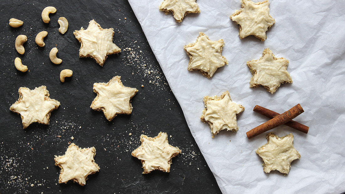 Vegan cinnamon stars made from apple and hazelnut dough with a cashew nut frosting