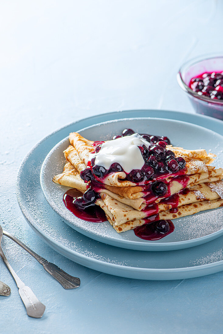 Crepes with blueberry sauce and yoghurt