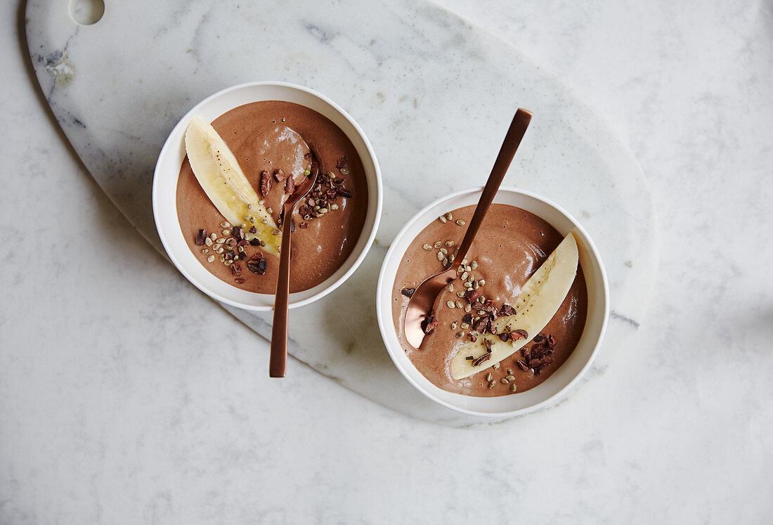 Chocolate and banana bowls with cashew nuts and hemp seeds