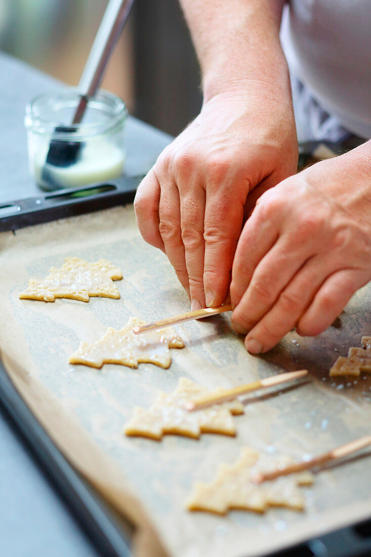 Prepare Christmas tree biscuits on a stick