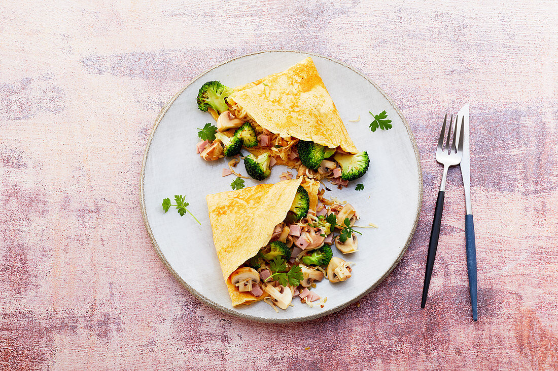 Stuffed pancakes with ham, mushrooms, broccoli and cheese