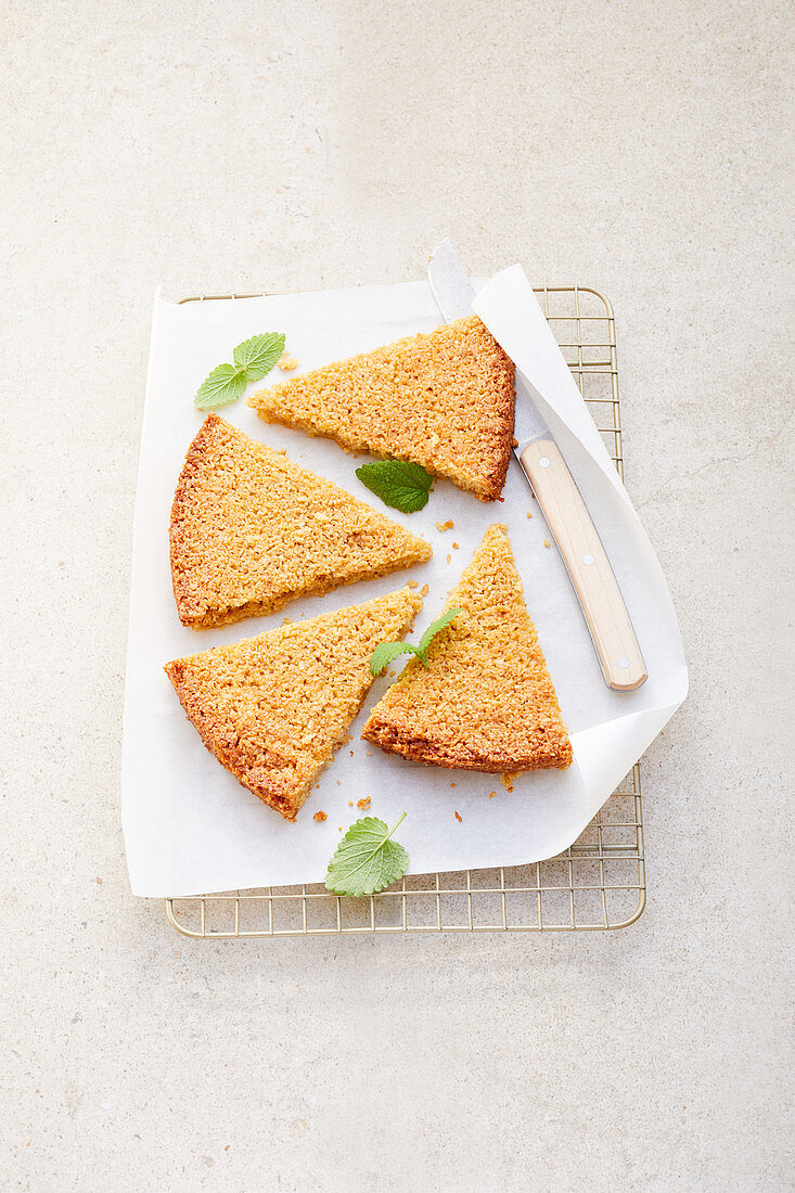 Partially Sliced Coconut Cake on a Cooling Rack