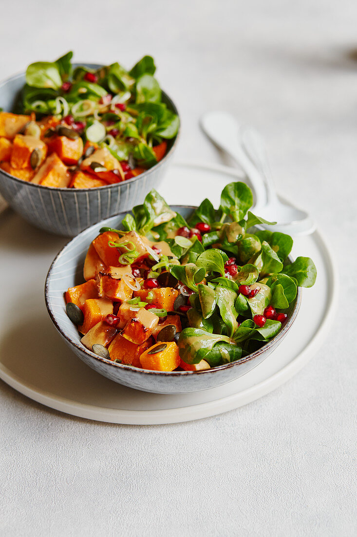 Oven-roasted butternut squash with lamb's lettuce and pomegranate seeds