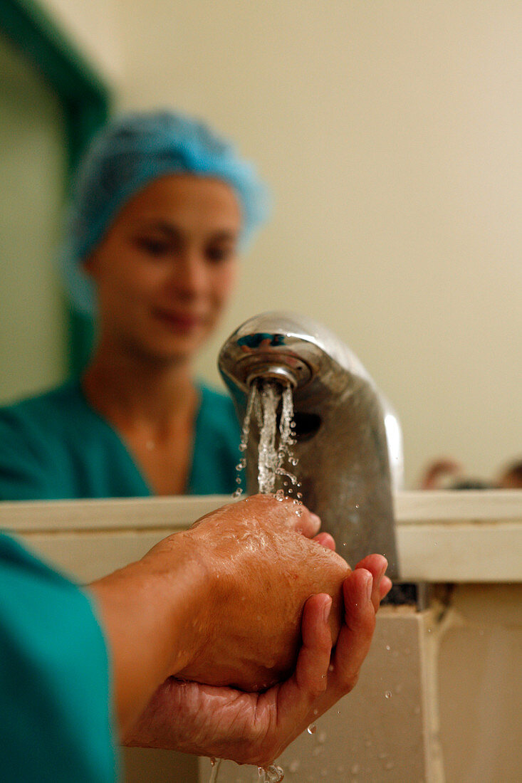 Surgeon washing hands prior to surgery