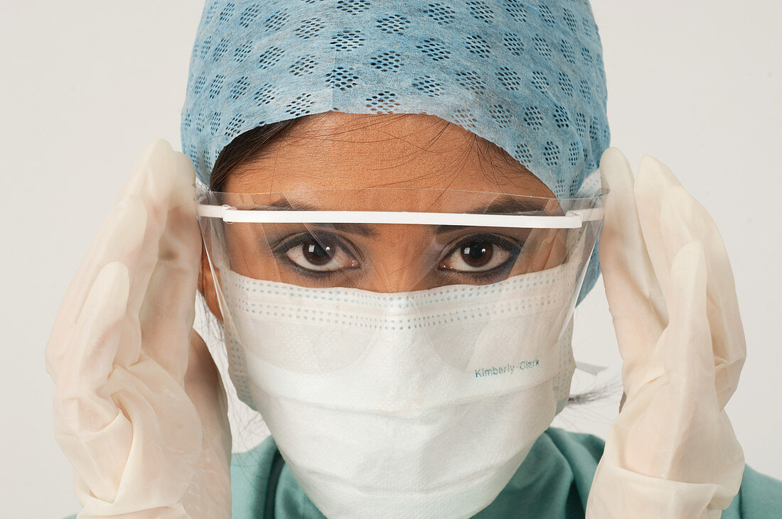 Surgeon putting on a surgical eye shield