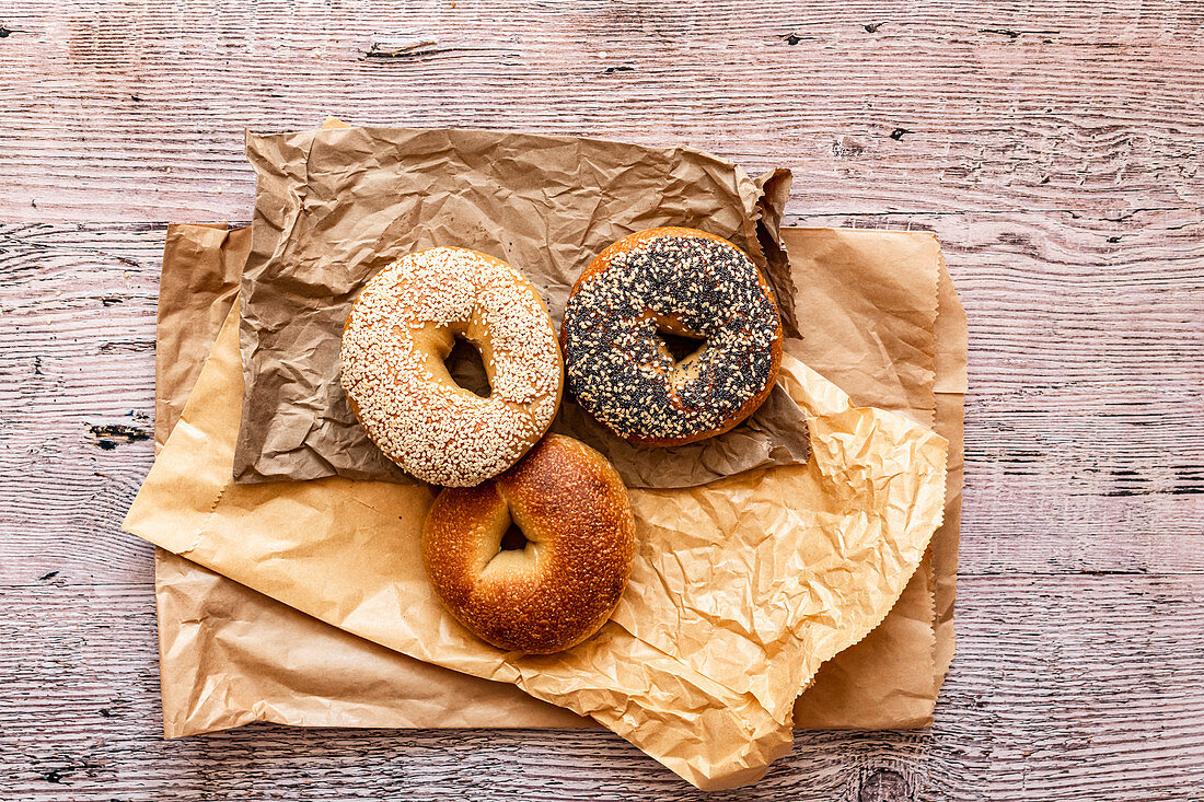 Selection of bagels on brown paper bags