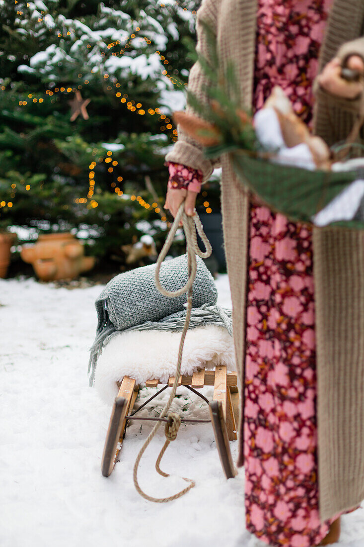 Woman pulling sledge through the snow