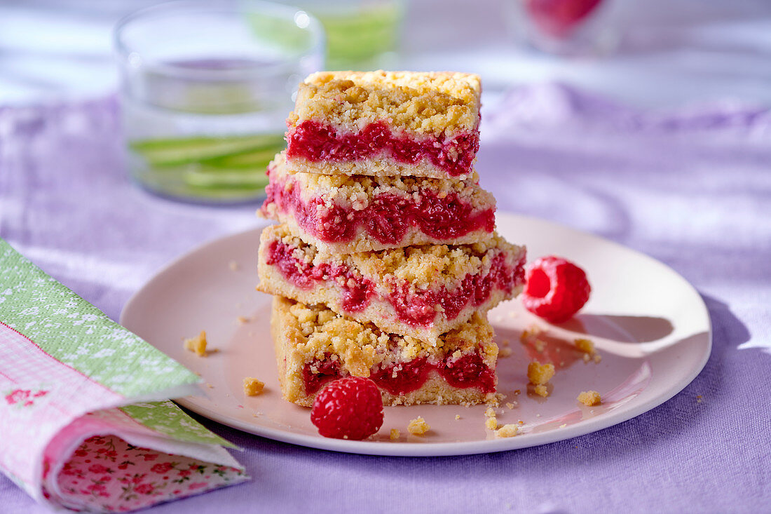 Several pieces of raspberry crumble cake, stacked