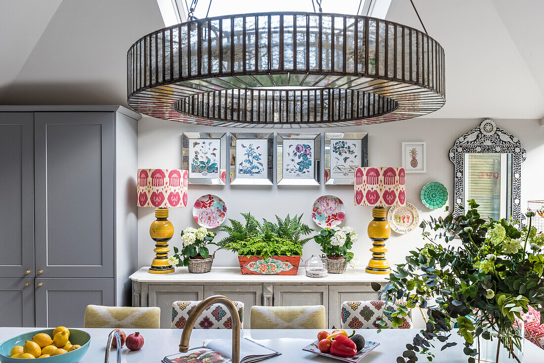 Striking Downton chandelier above breakfast bar with upcycled seating