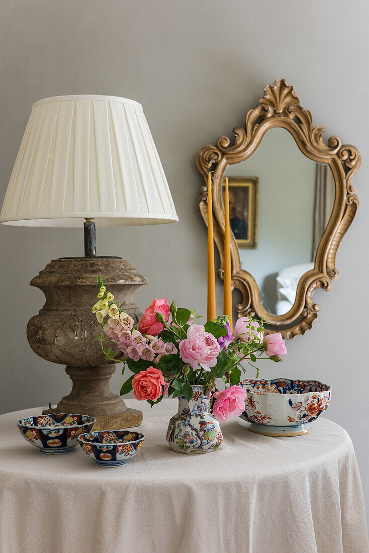 Antique china and lamp on table