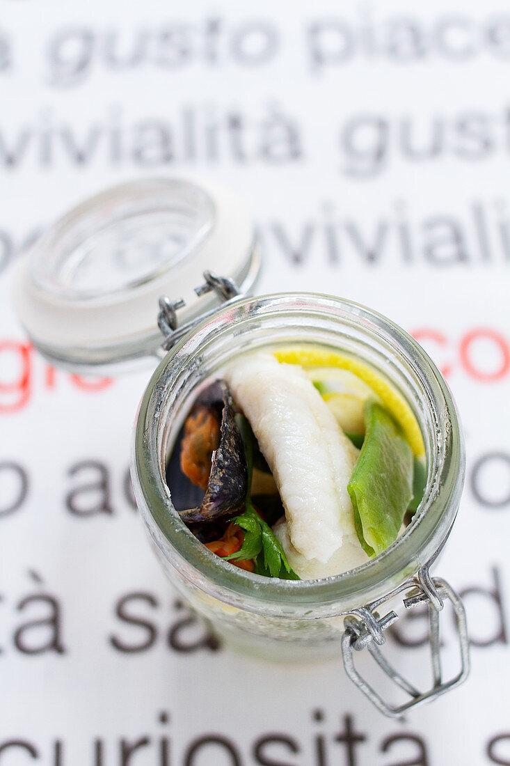 Pickled sole with mussels in a glass jar
