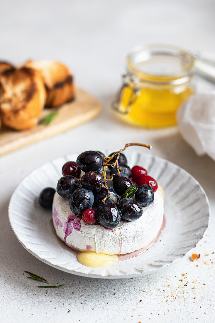 Baked camembert with red grapes and cranberries