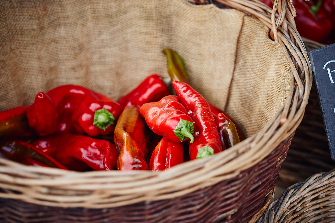 Red peppers in a basket on a market stall