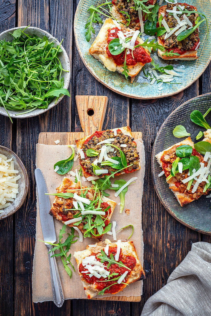 Crostini mit Ragout, Oliven, Pilzen und Rucola