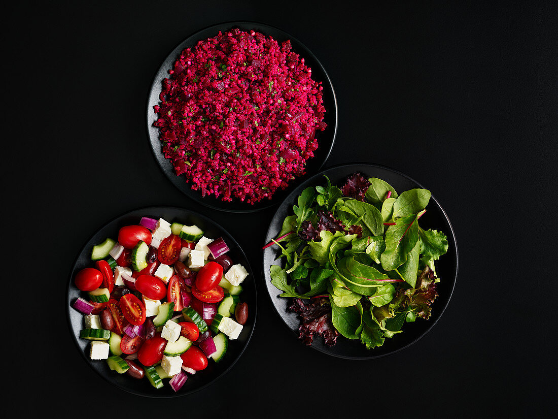 Three different salads in bowls