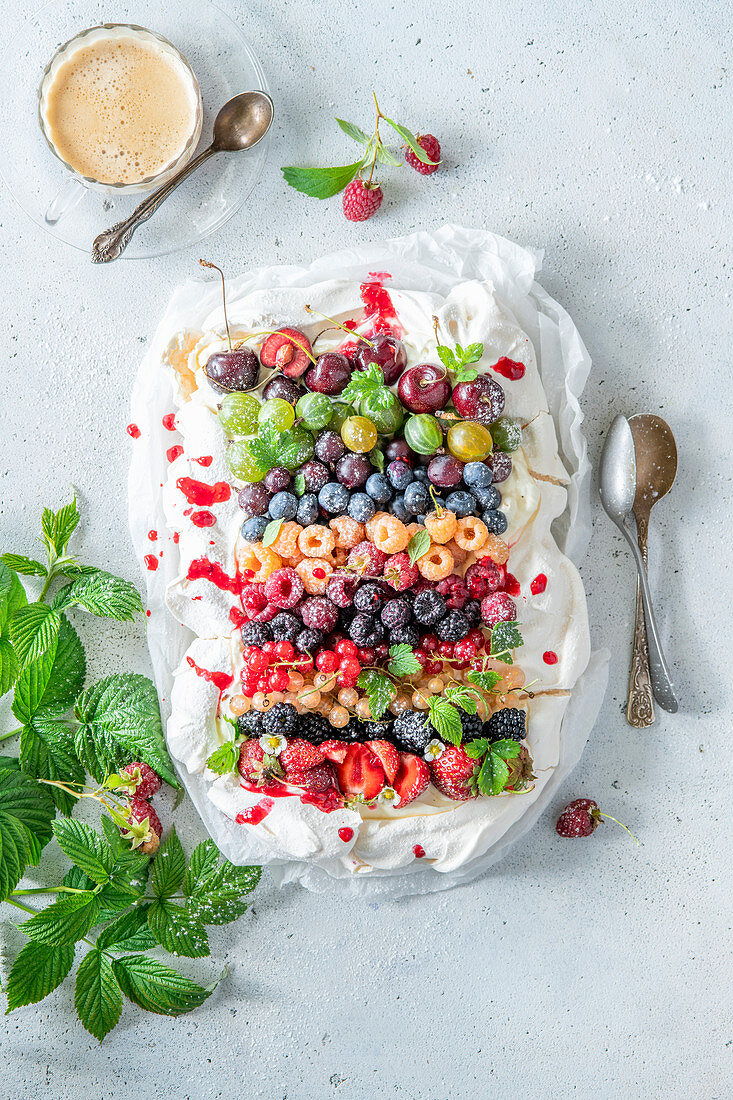 Rainbow pavlova with summer berries