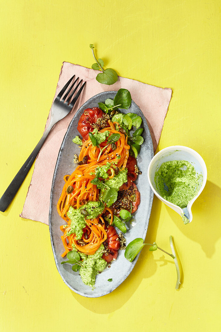 Carrot noodles with pumpkin seed tomatoes and watercress pesto