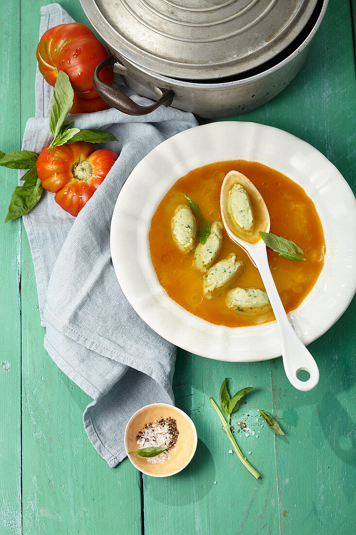 Tomato consommé with herb dumplings