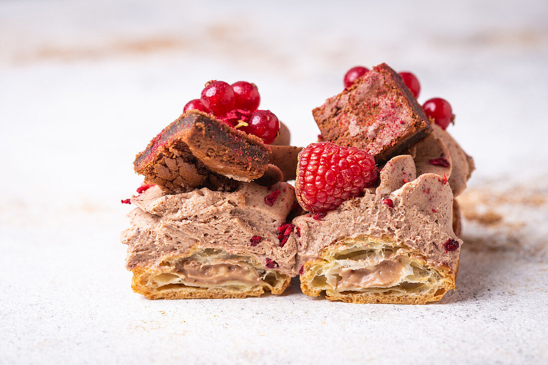 Eclairs with chocolate cream, brownie and berries