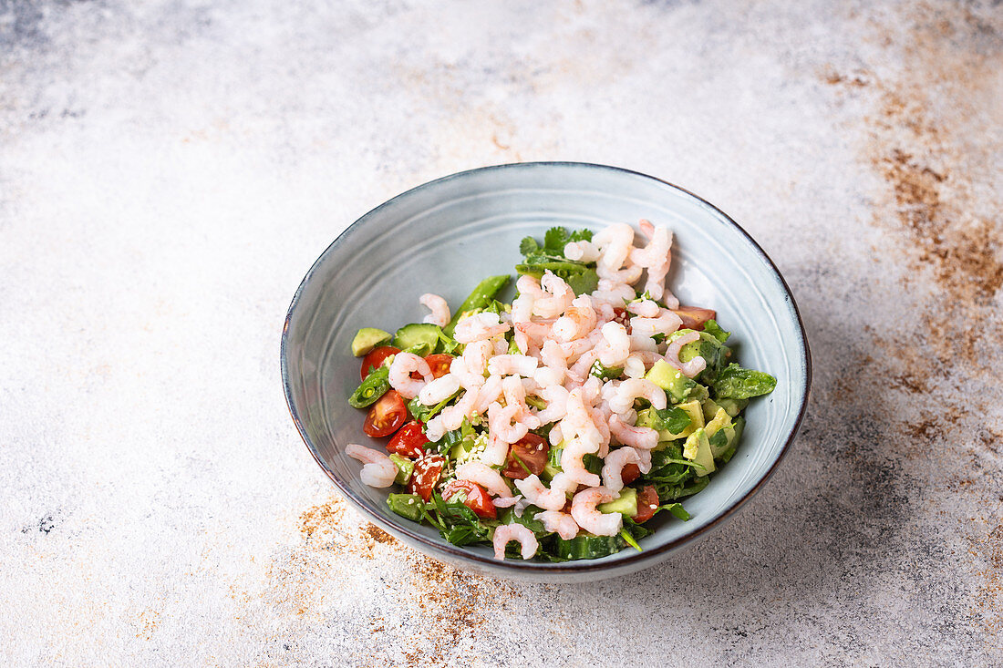 Shrimps, avocado, cilantro, tomato, cucumber and sugar snap salad