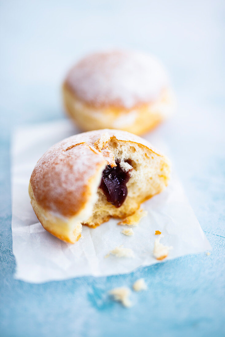 Berlin pancakes (donuts) with plum jam and powdered sugar