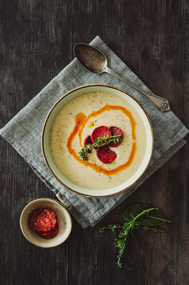 Creamy potato soup with thyme and spicy salsiccia