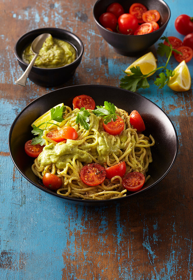 Pasta with avocado sauce and cherry tomatoes