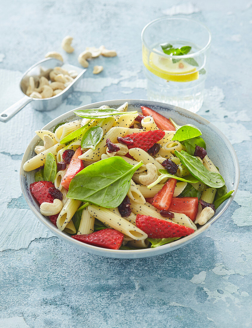 Pasta salad with spinach, strawberries and poppy seed vinaigrette