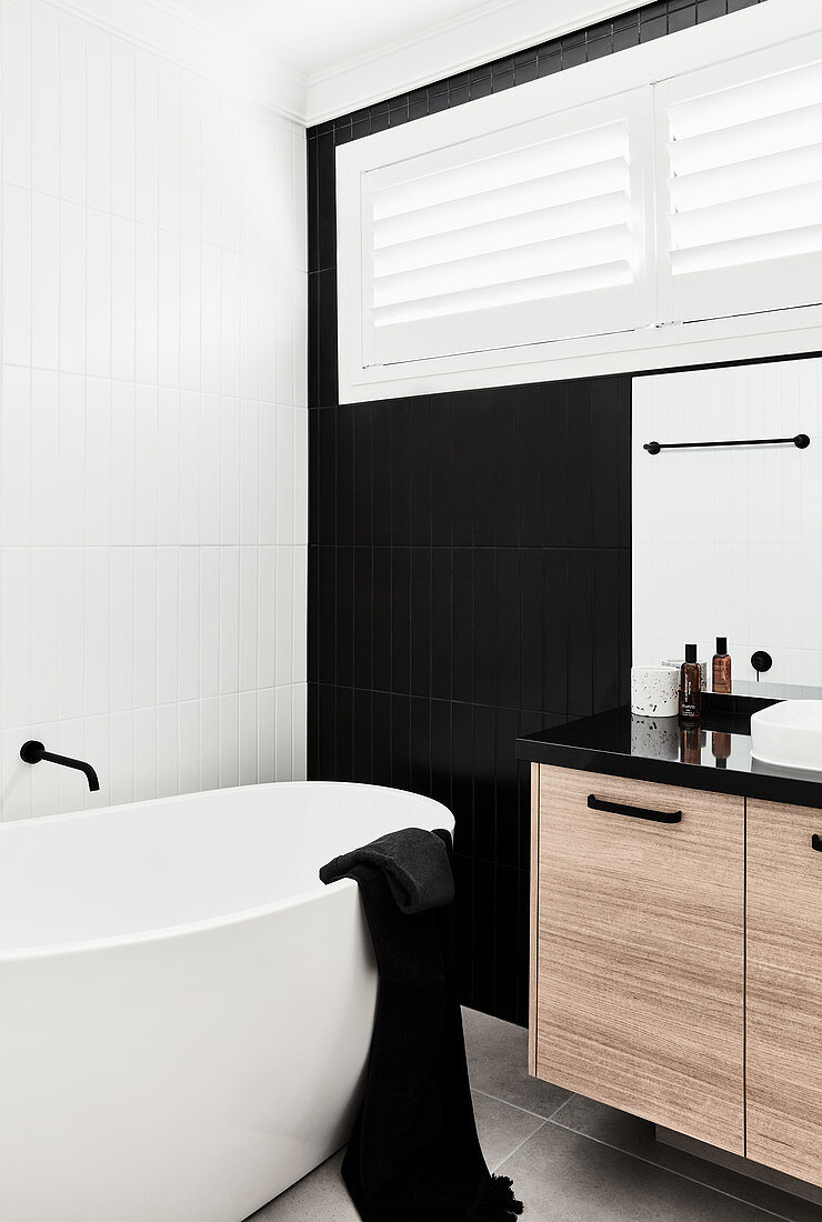 Freestanding bathtub in modern monochrome bathroom