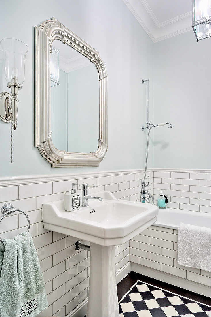 Tiled dado and palest blue walls in classic bathroom