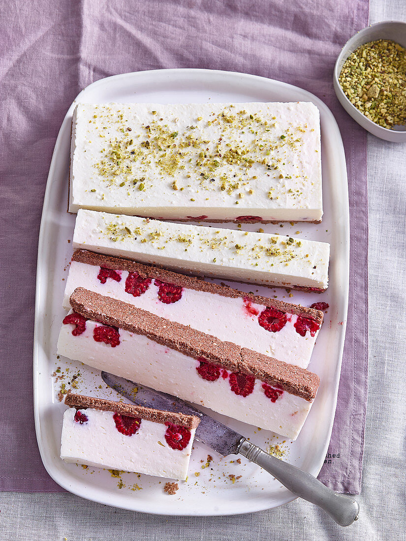 Custard cuts with raspberries and pistachios