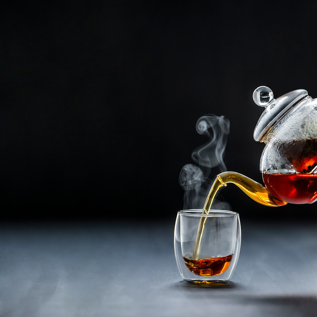 Pouring black tea, steaming