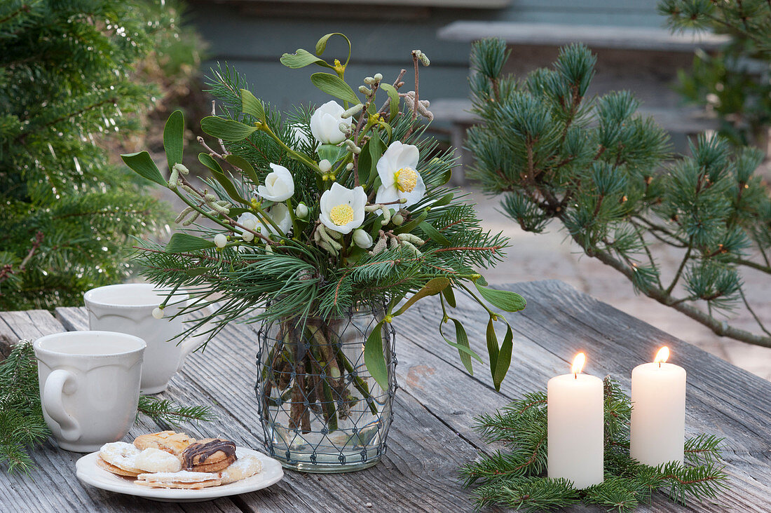 Christmas bouquet of Christmas rose and branches of pine, spruce, mistletoe and hazelnut