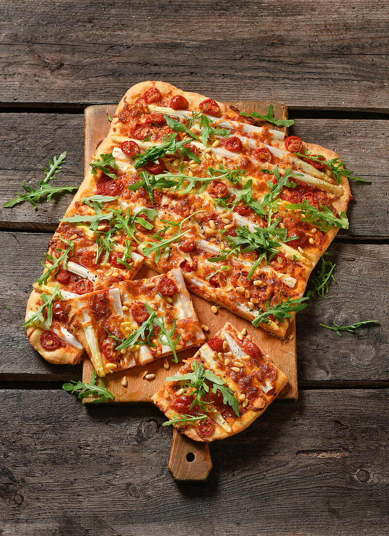 Asparagus pizza with rocket and pine nuts