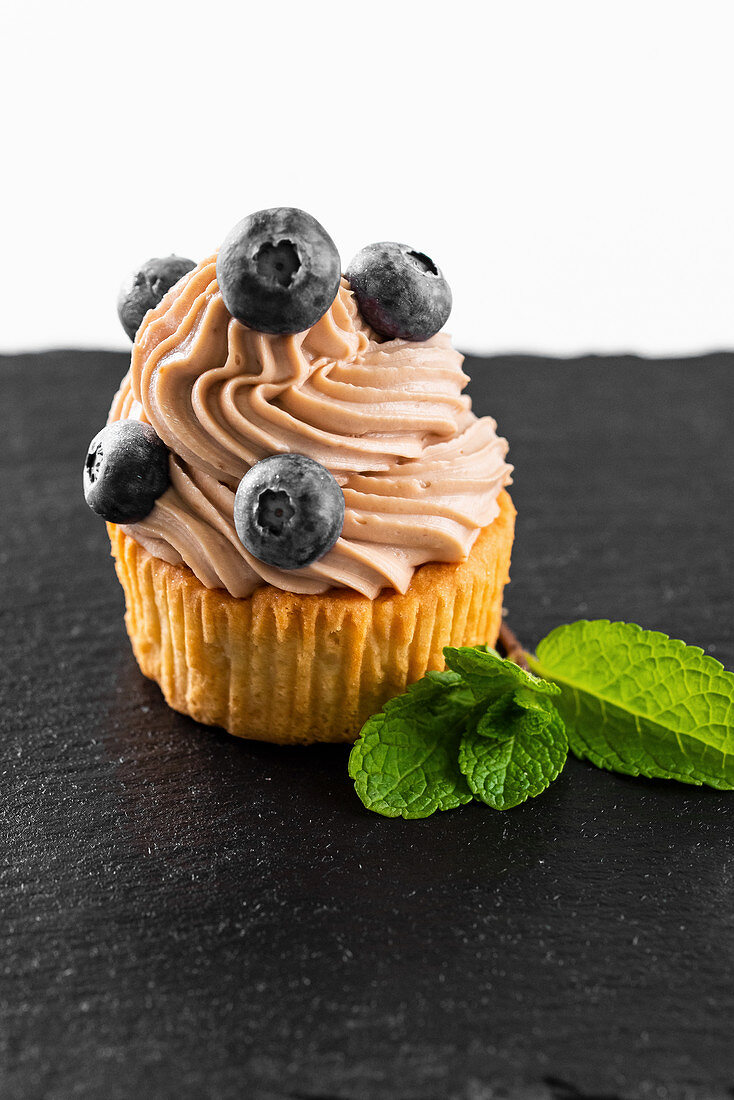 Cupcake with buttercream and blueberries