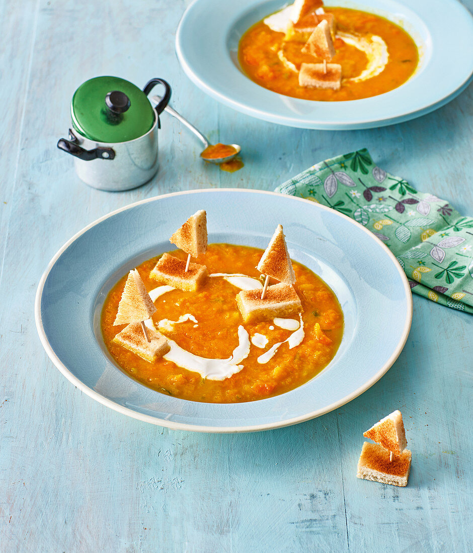 Carrot soup with toast boats