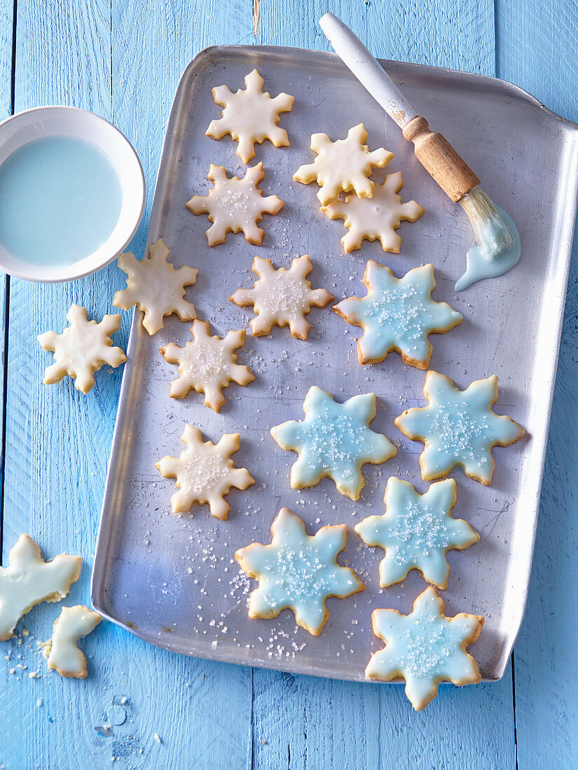 Schneeflocken-Plätzchen mit himmelblauer Zuckerglasur