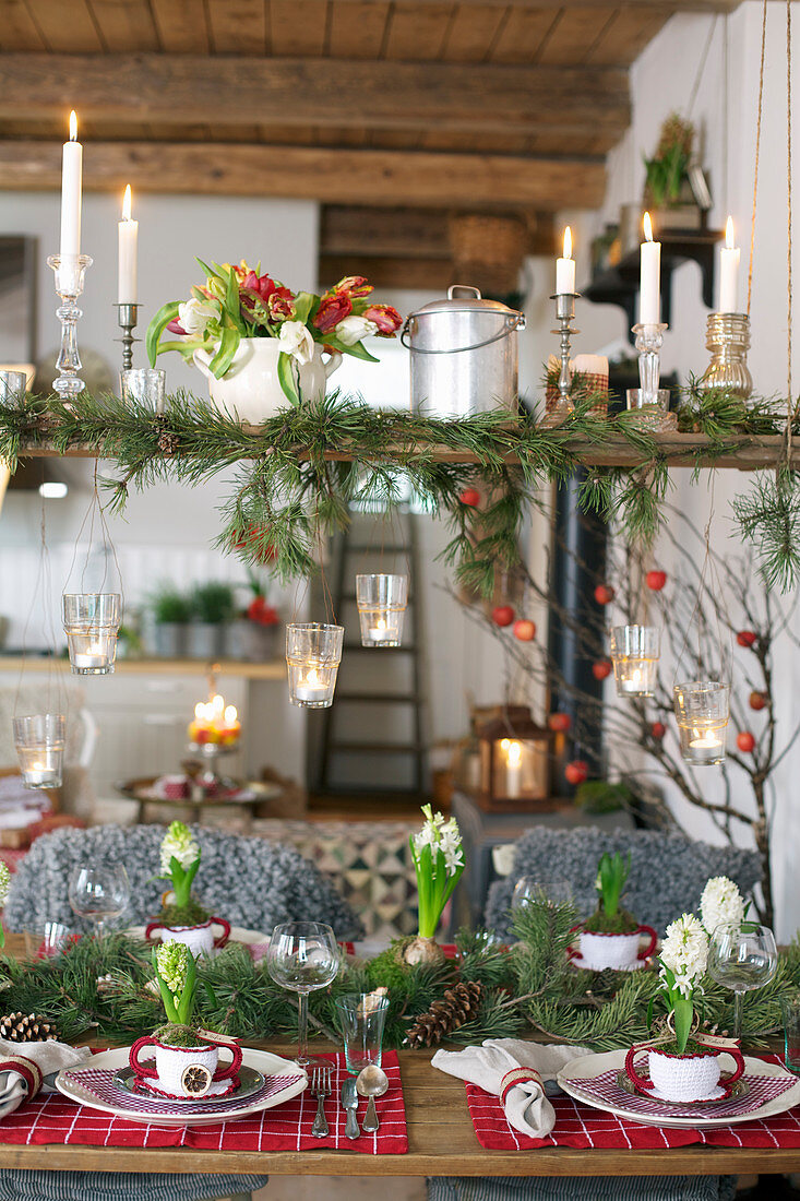 Christmas table and shelf decorated with fir branches and flowers