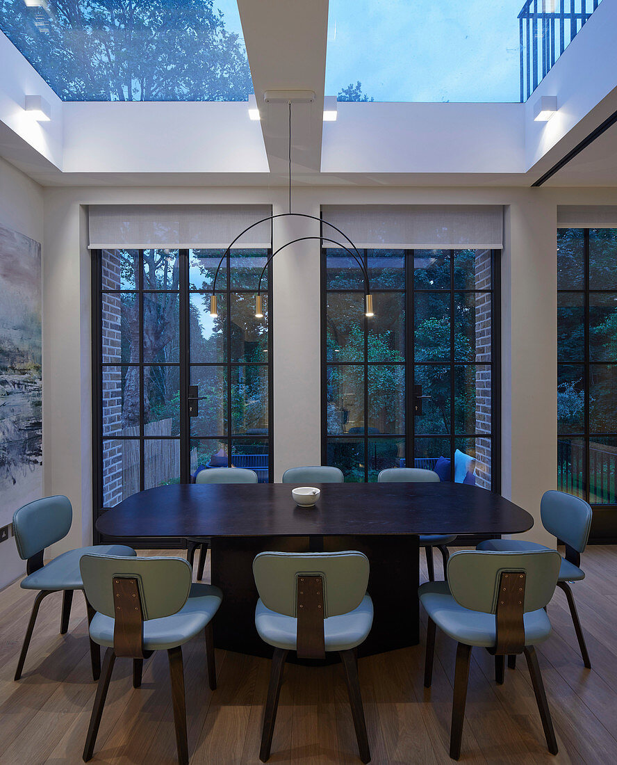 Dining room with lattice windows and skylights at twilight